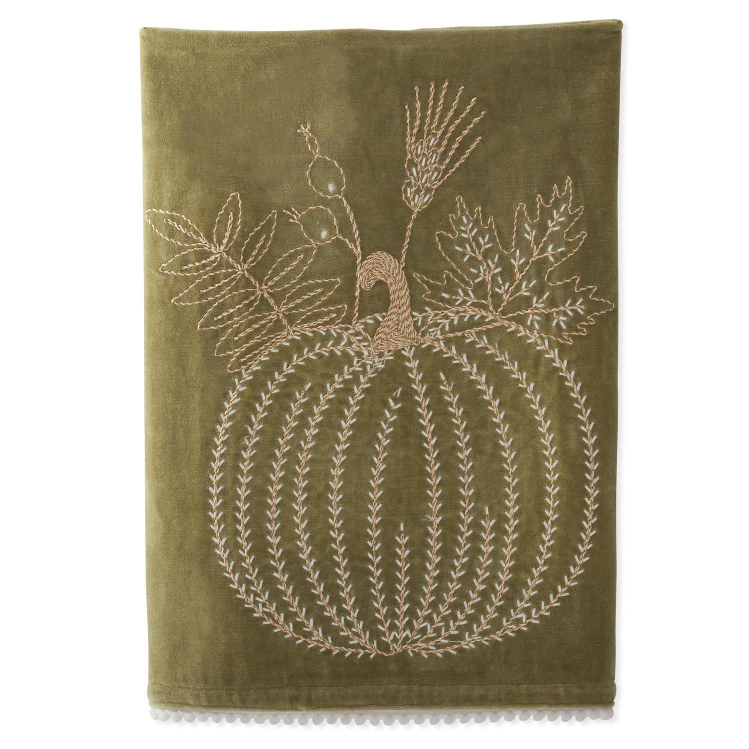 Green towel with embroidered pumpkin design on a white background